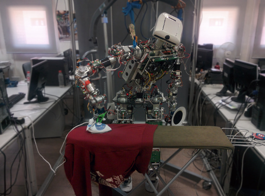 Humanoid robot ironing garments